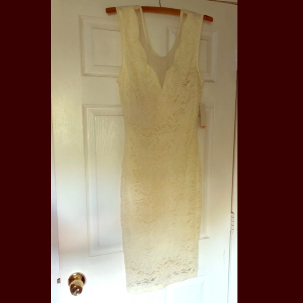 Midi length cream colored bodycon dress.